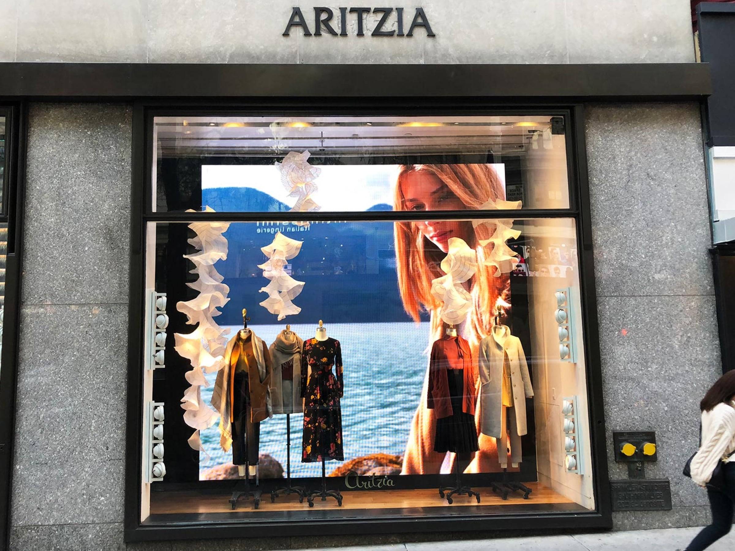 A digital window screen on a window of a retail store.