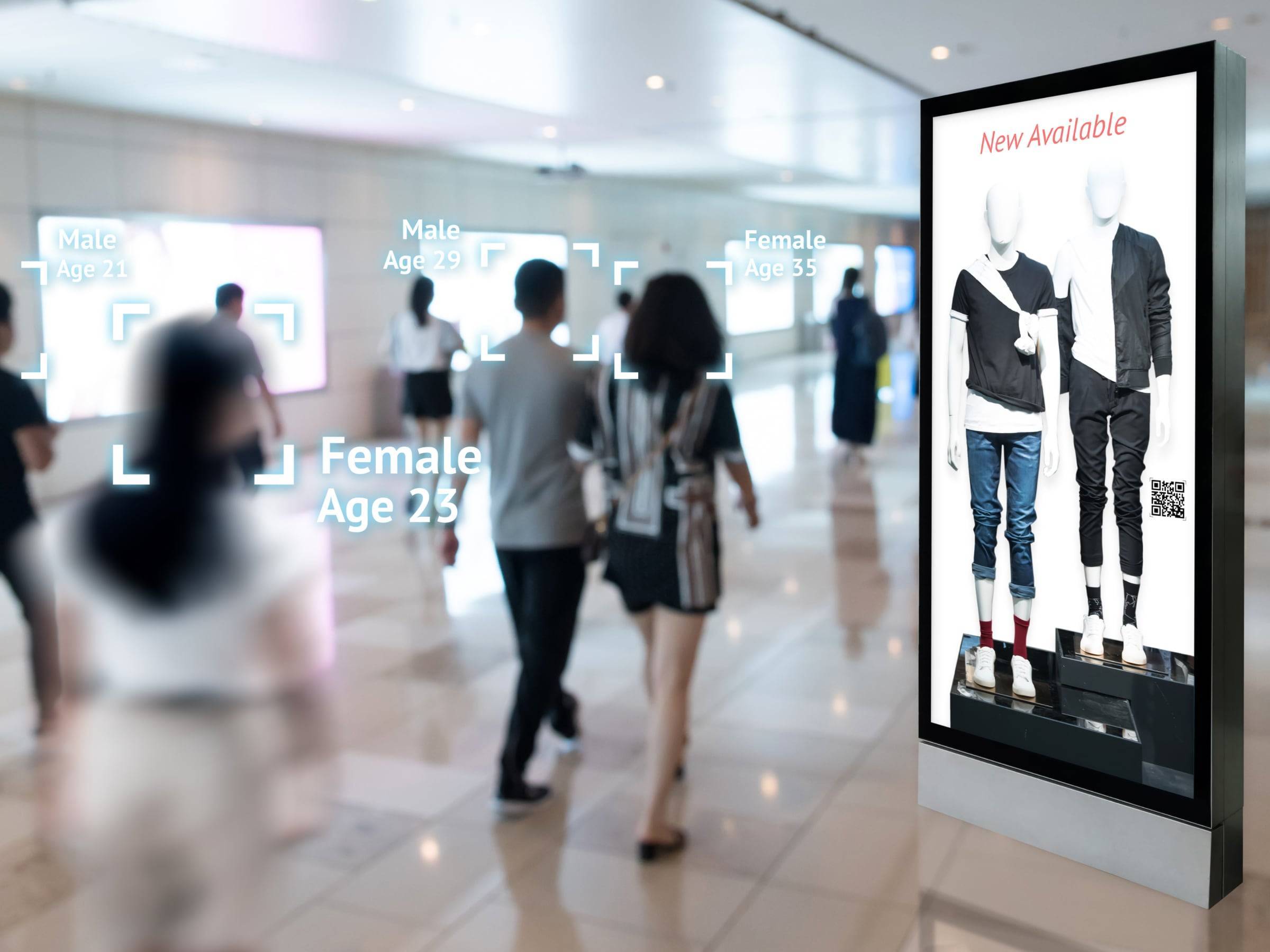 a couple passing by digital signage of a retail shop with a customized advertising.