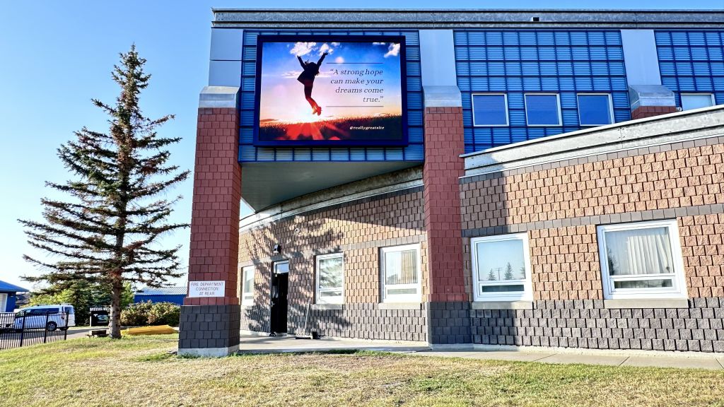 Morinville Community High School digital billboard at a construction site.